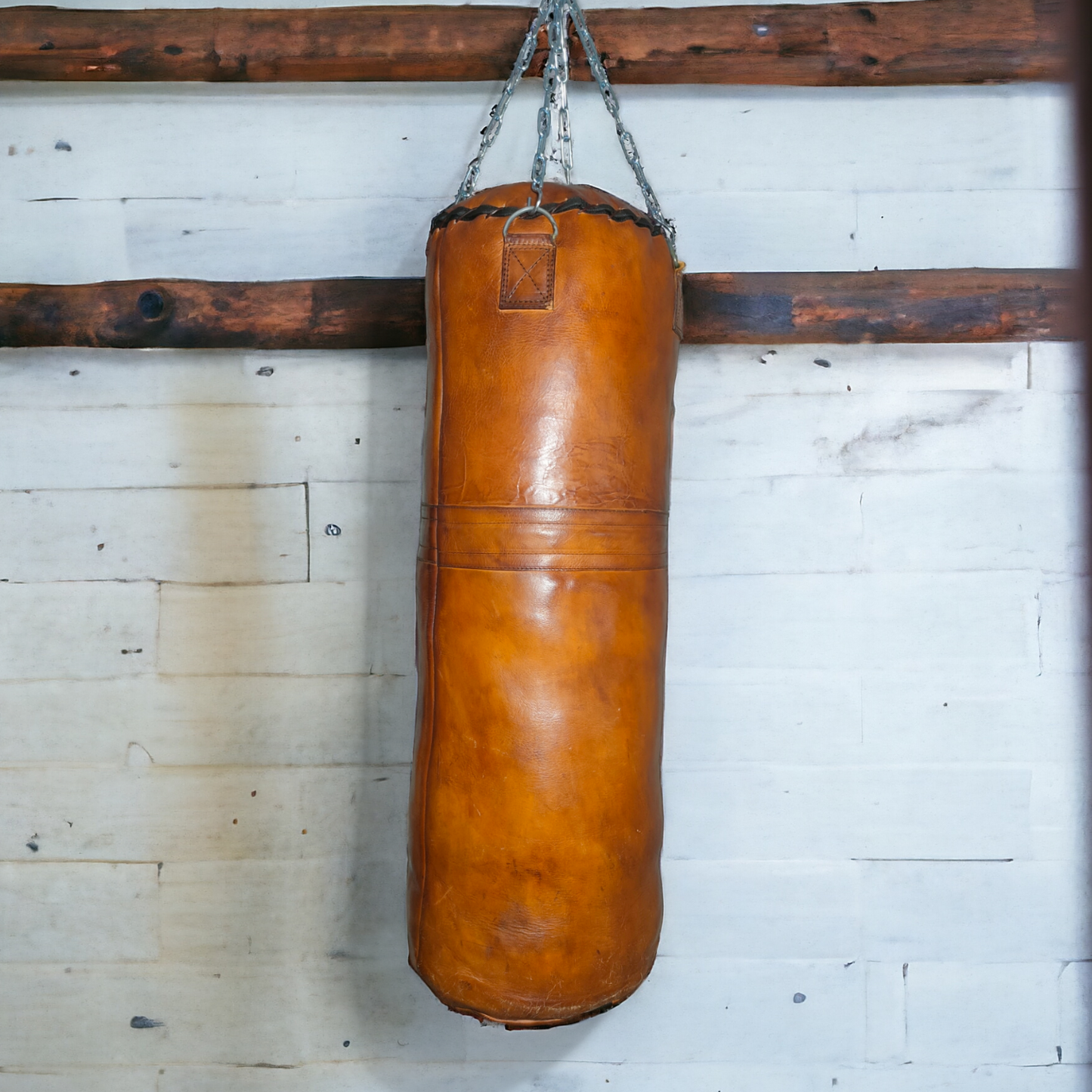leather punching bag handing from a wall in an old gym