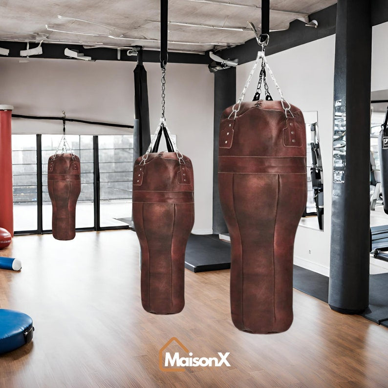 The upper cut heavy bag displayed in multiple sizes—the 3ft, 4ft, 5ft, and 6ft punching bag options—hanging side-by-side to illustrate the full range available. leather punching bag, heavy bag, boxing bag, kickboxing bag, Muay Thai heavy bag, free standing punching bag, hanging punching bag, speed bag, double end bag, aqua training bag, water heavy bag, uppercut bag, maize bag, wrecking ball bag, reflex bag, cobra bag, training dummy, professional heavy bag, gym punching bag, home gym heavy bag, filled punc