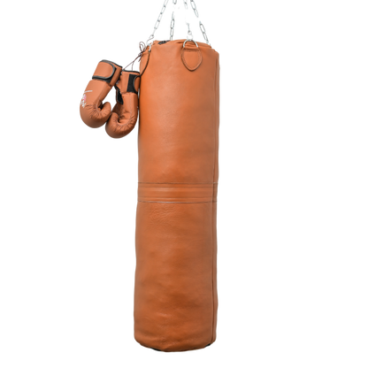 leather punching bag hanging with chains and gloves present on its side. best training bag in the market
