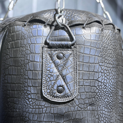 close up of purple leather crocodile skin punching bag
