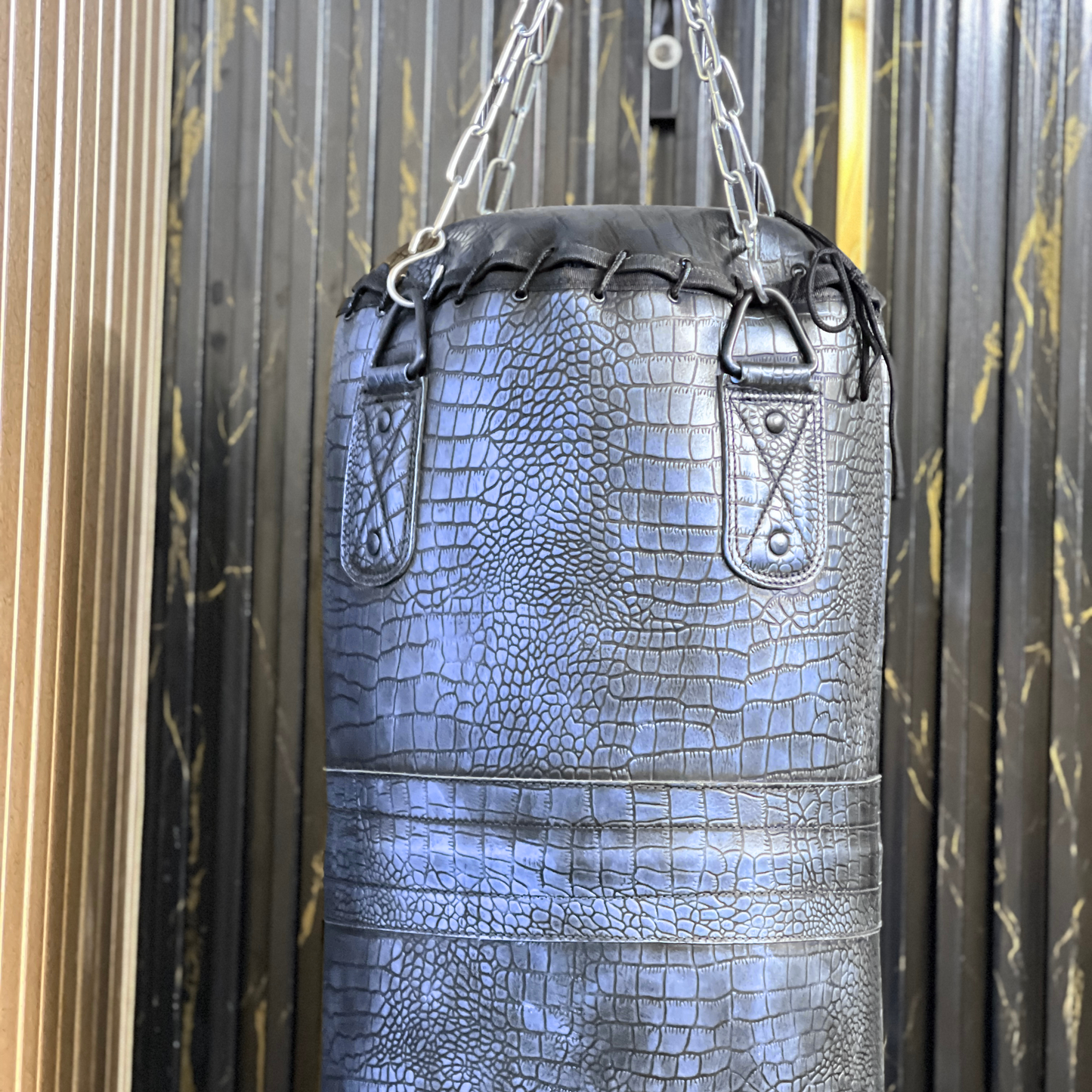 hd pictures of leather punching bag of purple color in crocodile pattern