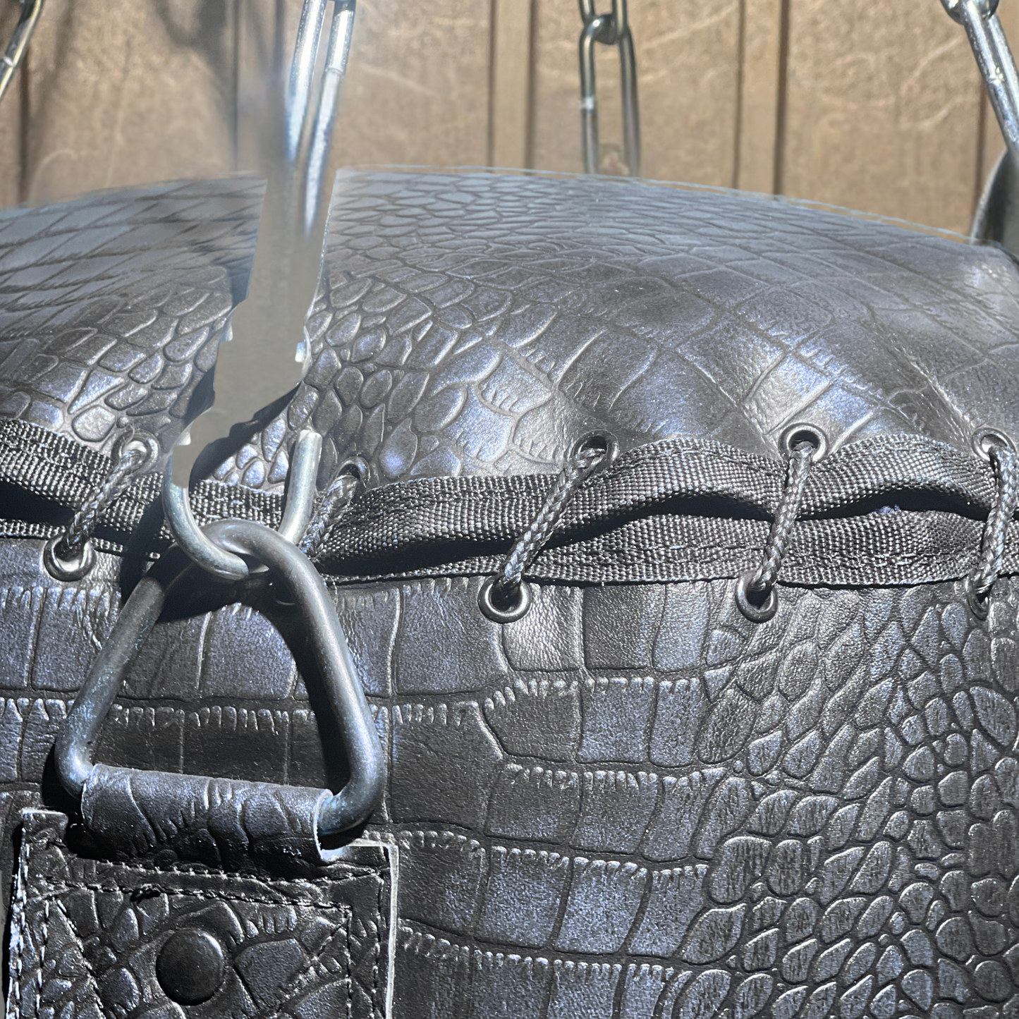 close up string closure of leather punching bag of purple color