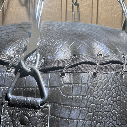close up string closure of leather punching bag of purple color
