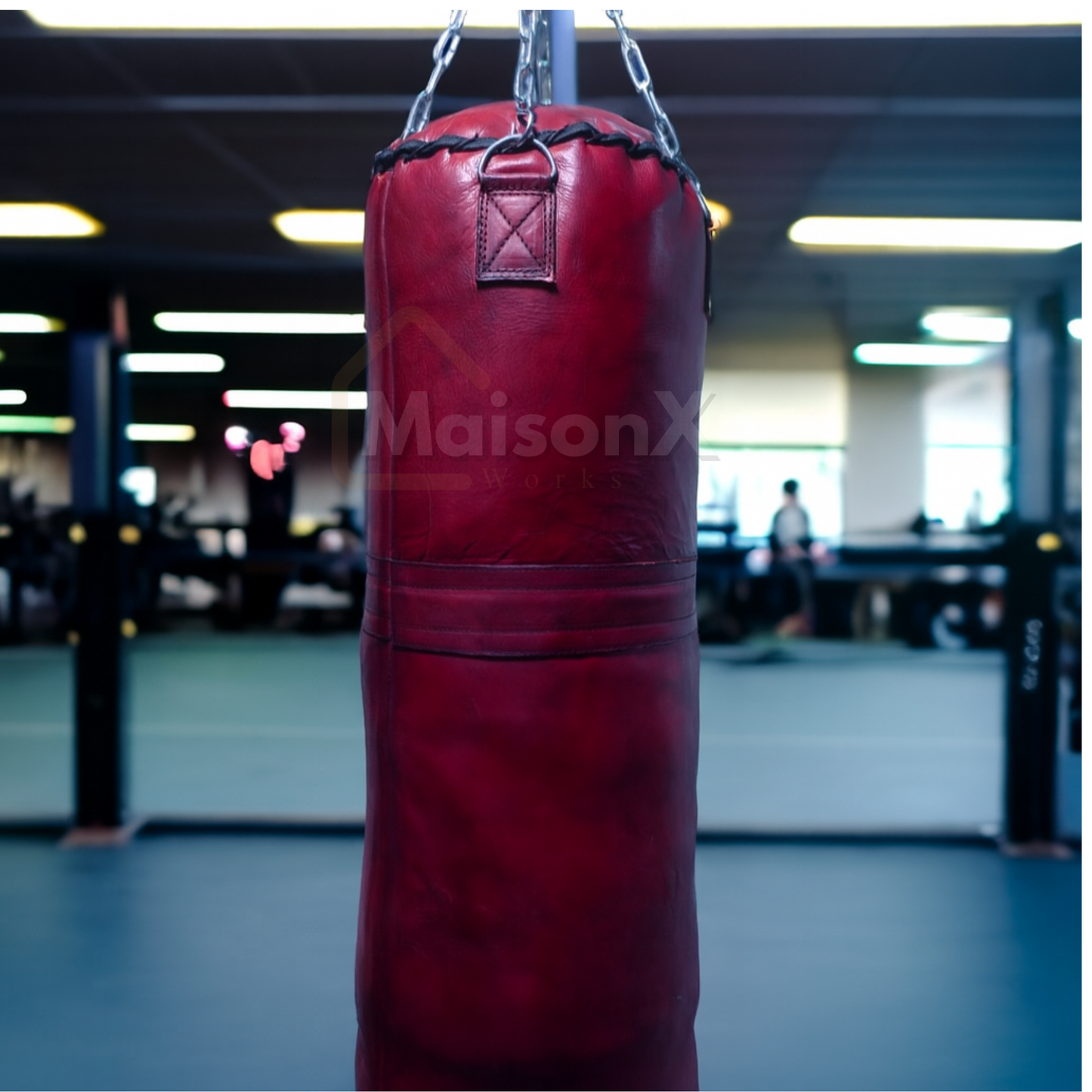 Leather burgundy punching bag against gym background hung with stainless steel chain.  with free shipping available. and also customization possible
