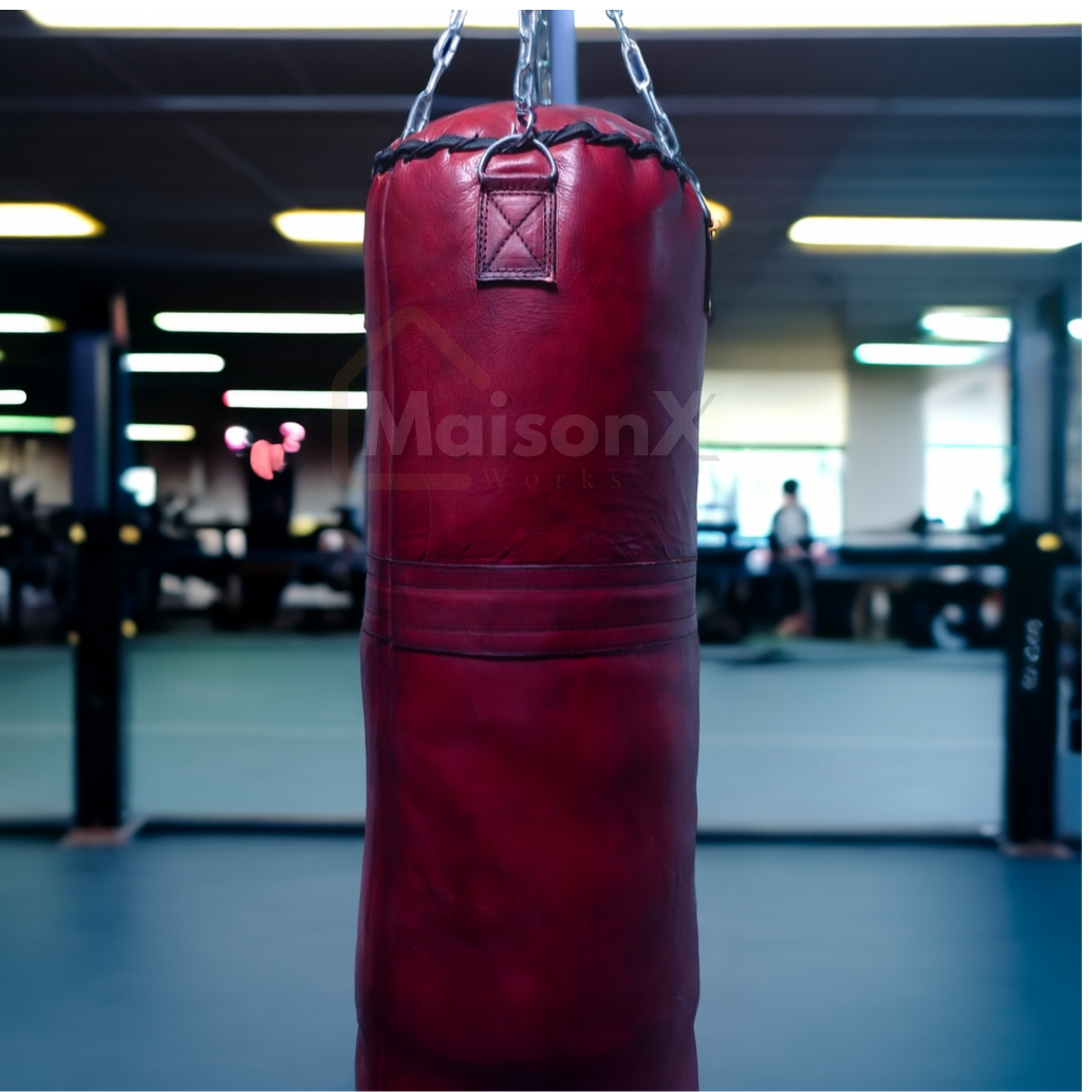 Leather burgundy punching bag against gym background hung with stainless steel chain.  with free shipping available. and also customization possible