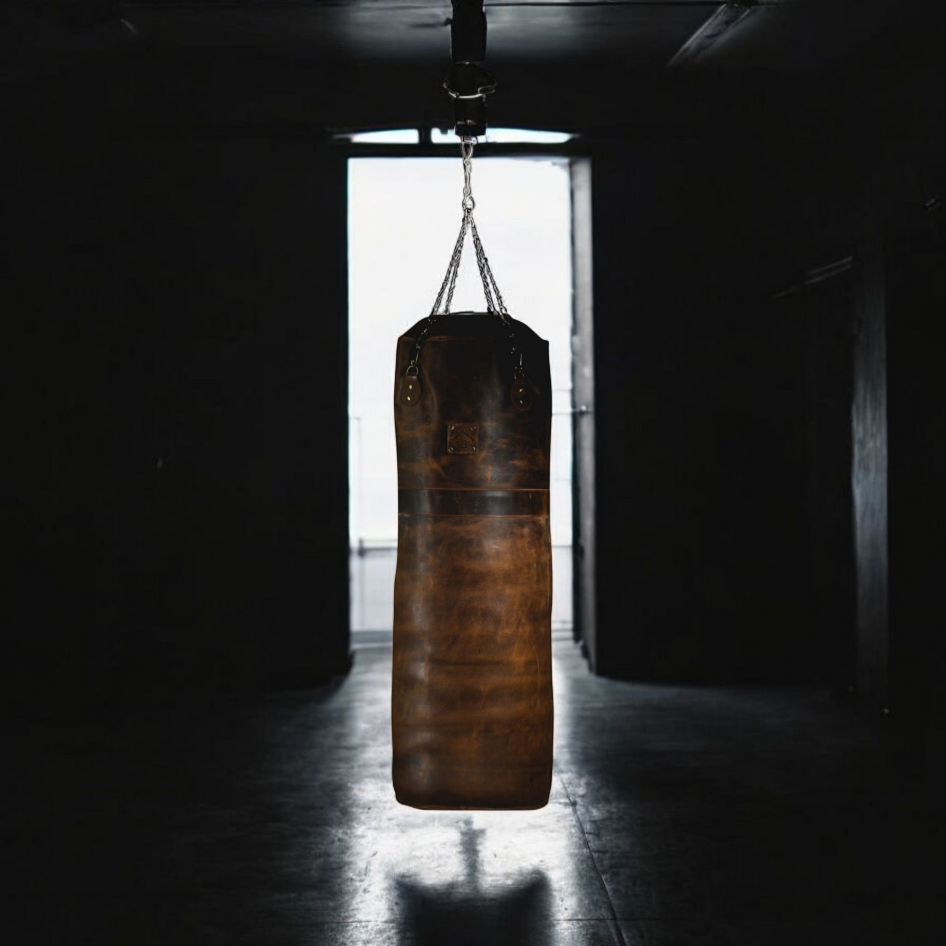 Two tone leather punching bag hanging in the gym with dark bacground.leather punching bag, heavy bag, boxing bag, kickboxing bag, Muay Thai heavy bag, free standing punching bag, hanging punching bag, speed bag, double end bag, aqua training bag, water heavy bag, uppercut bag, maize bag, wrecking ball bag, reflex bag, cobra bag, training dummy, professional heavy bag, gym punching bag, home gym heavy bag, filled punching bag, unfilled heavy bag, synthetic leather punching bag, durable heavy bag, 100lb punch