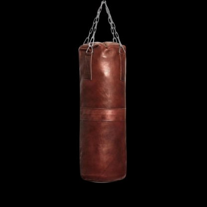 leather heavy bag agaisnt black background. leather punching bag, heavy bag, boxing bag, kickboxing bag, Muay Thai heavy bag, free standing punching bag, hanging punching bag, speed bag, double end bag, aqua training bag, water heavy bag, uppercut bag, maize bag, wrecking ball bag, reflex bag, cobra bag, training dummy, professional heavy bag, gym punching bag, home gym heavy bag, filled punching bag, unfilled heavy bag, synthetic leather punching bag, durable heavy bag, 100lb punching bag, heavy bag stand,